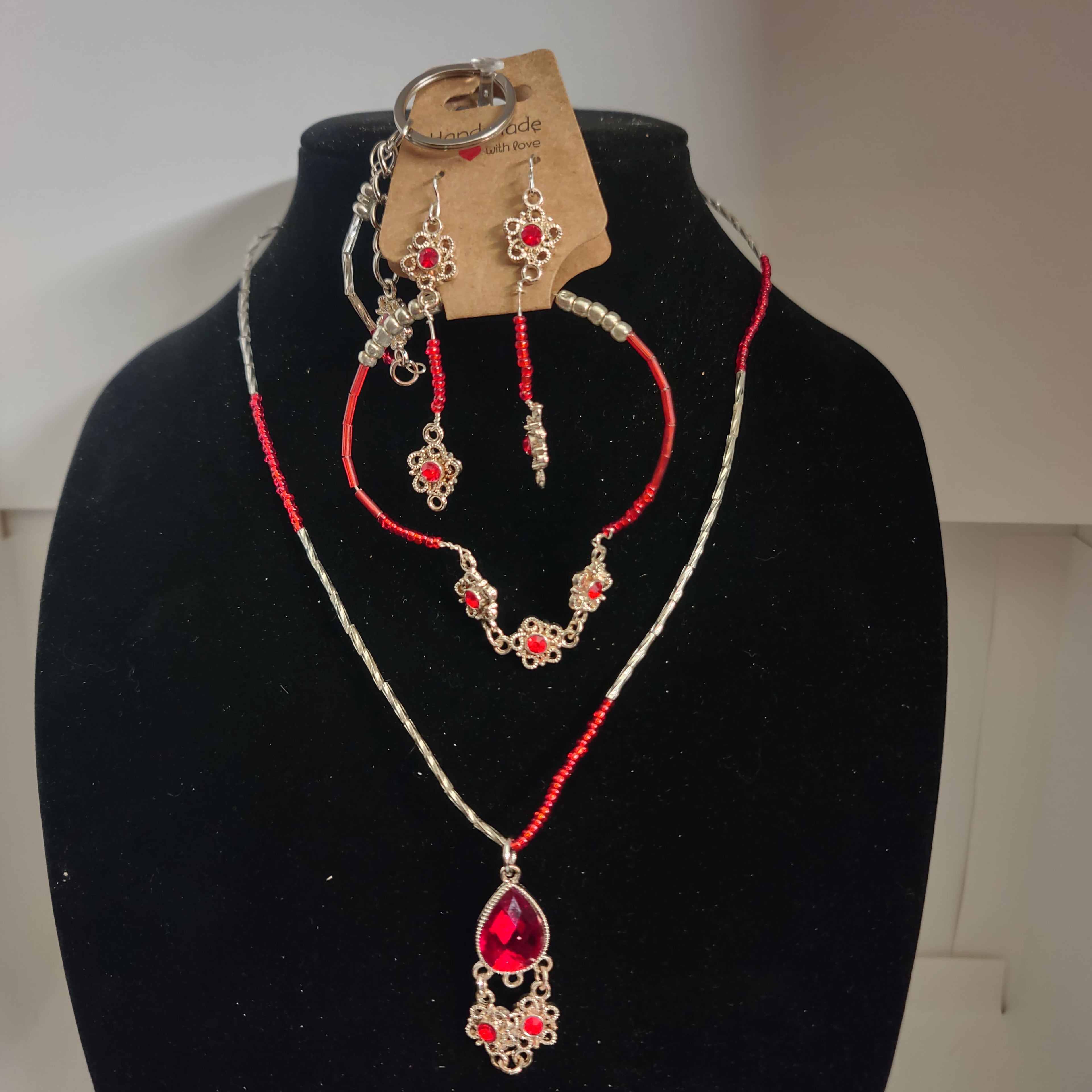 Beaded and jeweled necklace, earring, bracelet set, and key chain